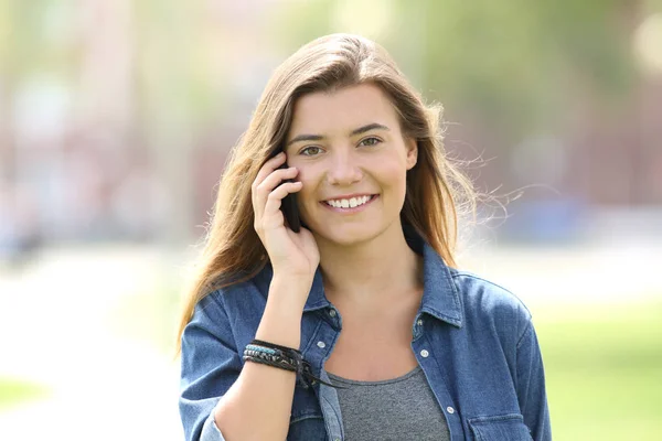 Teen walking and calling on phone looking at you — Stock Photo, Image