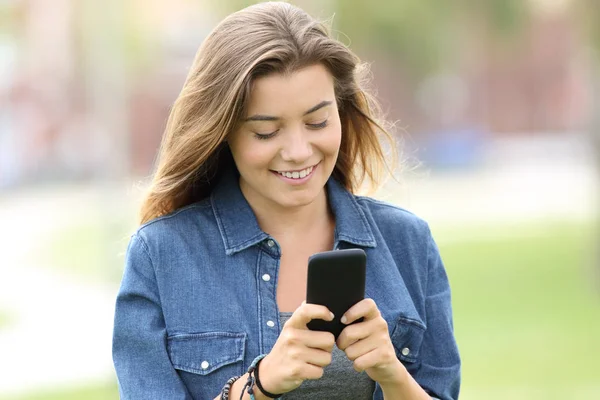 Adolescente leyendo texto en un teléfono inteligente — Foto de Stock