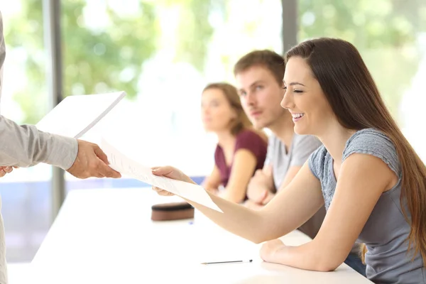 Student receiving an exam from the teacher — Stock Photo, Image