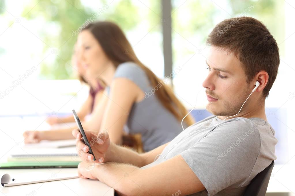 Bad student distracted listening music in classroom