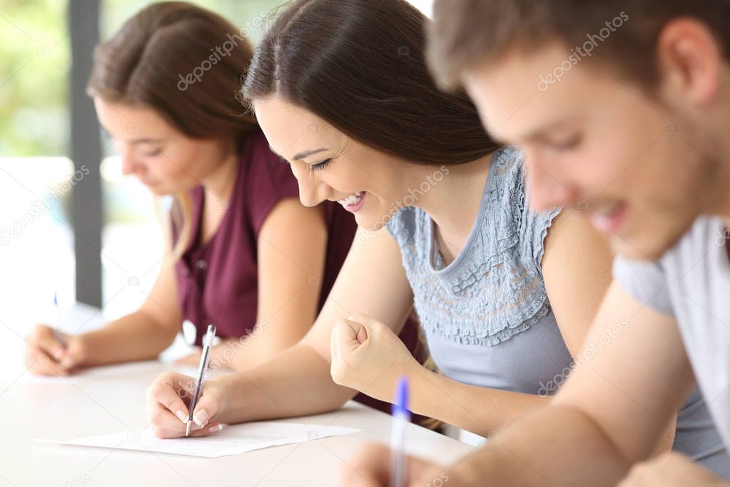 Excited student during an exam at classroom