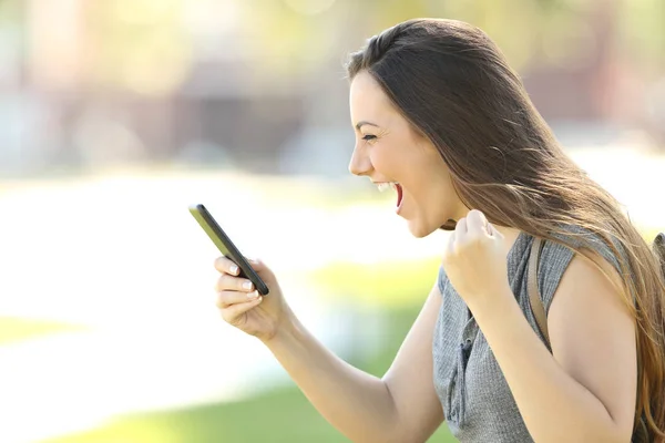 Profil d'une femme excitée utilisant un téléphone — Photo