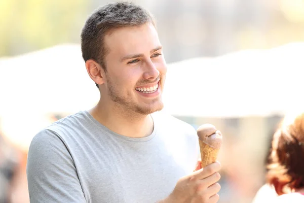 Man walking and holding a chocolate ice cream