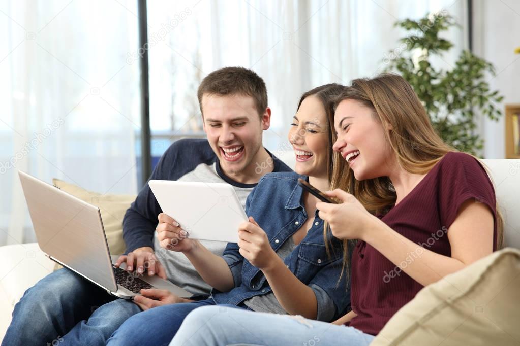 Friends laughing hard watching videos at home