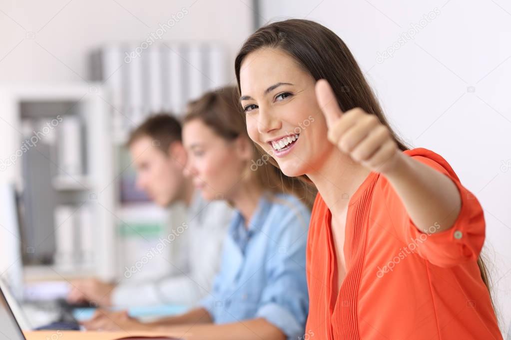 Happy employee looking at you with thumbs up