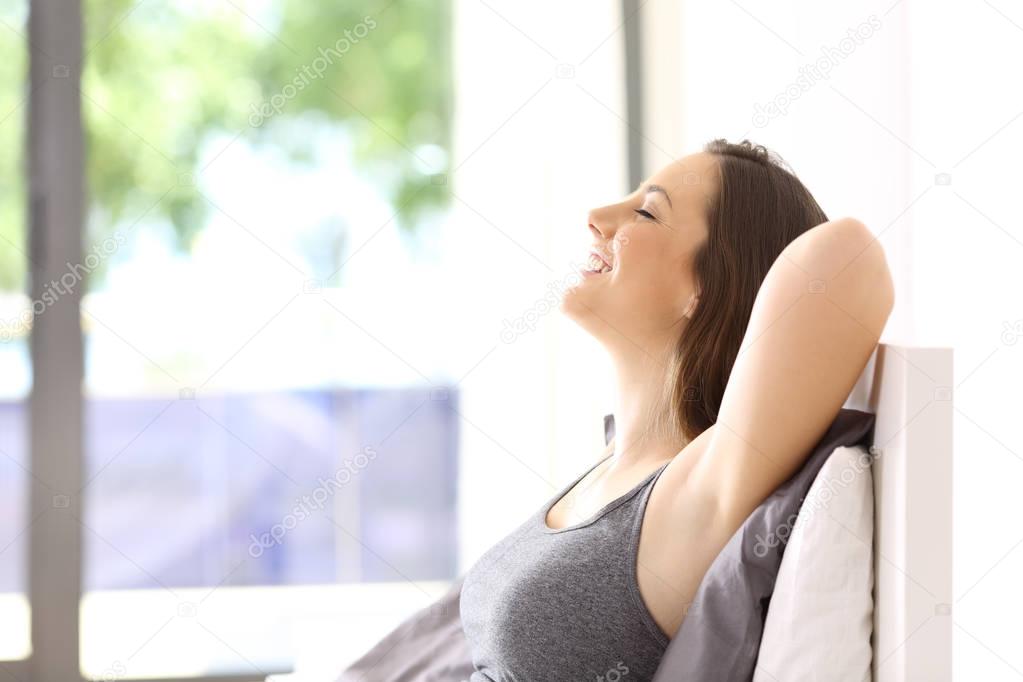 Woman relaxing on the bed in an hotel room