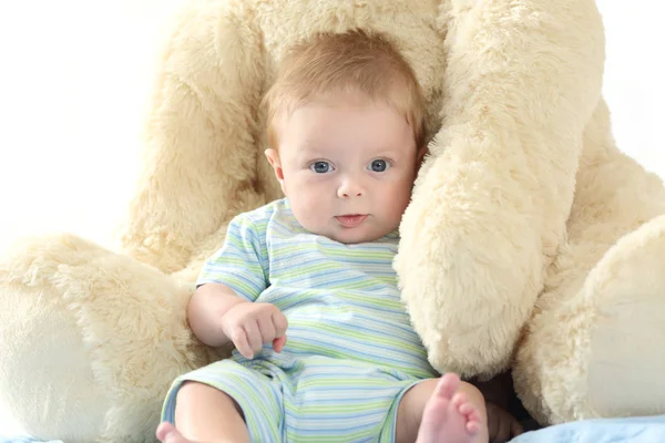 Baby und Teddybär schauen dich an — Stockfoto