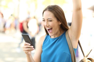Excited woman receiving good news on phone clipart