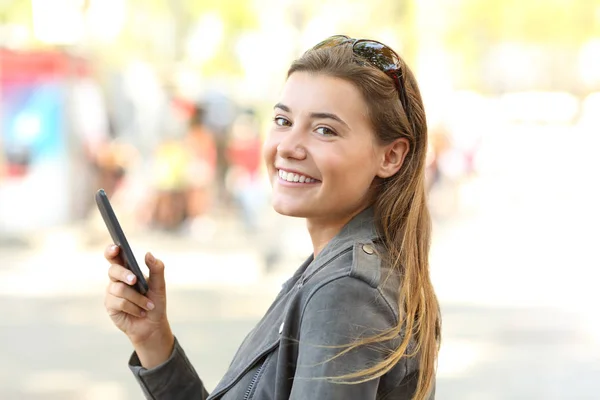 Adolescent avec téléphone mobile regardant caméra — Photo