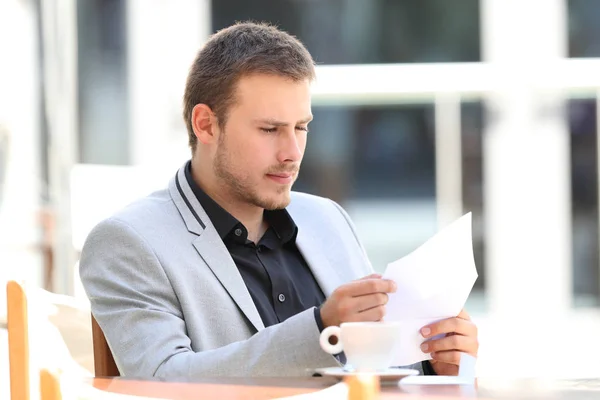 Esecutivo leggere una lettera in una caffetteria — Foto Stock