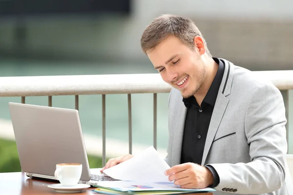 Happy executive reading documents in a bar — Stock Photo, Image