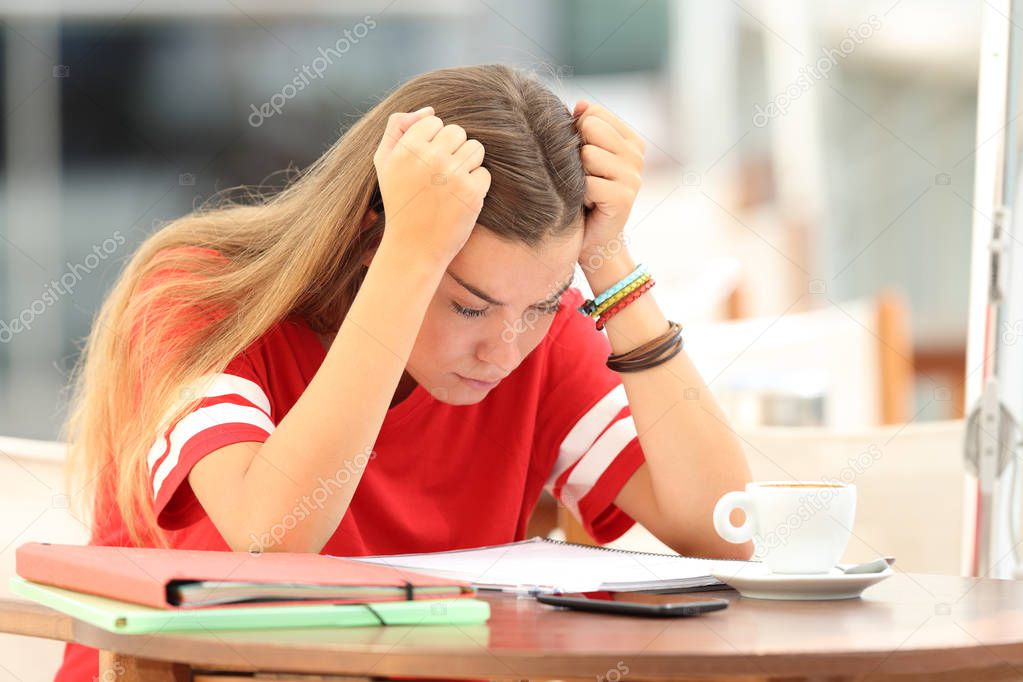 Frustrated student trying to understand notes in a bar