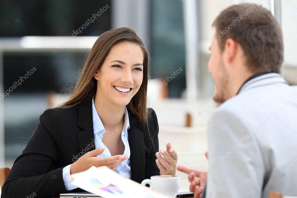 Two executives having a business conversation in a bar