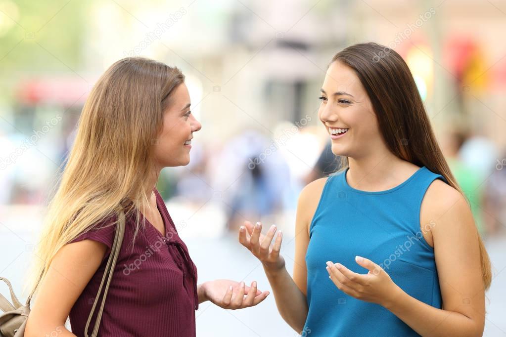 Friends meeting and talking on the street