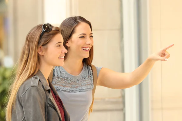 Due clienti felici che guardano un negozio — Foto Stock