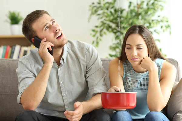 Couple calling insurance for home leaks — Stock Image Couple calling insurance for home leaks Stock Photo