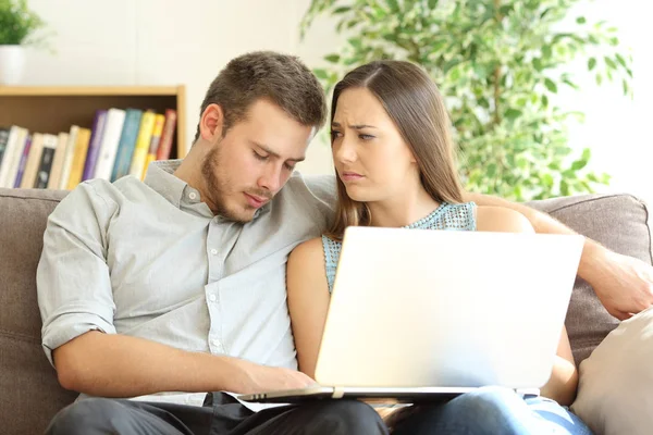 Bored boyfriend watching on line content on a laptop — Stock Photo, Image