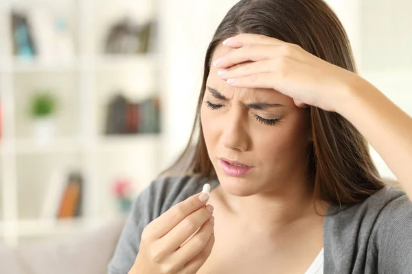 Ill woman suffering headache taking a pill — Stock Photo, Image