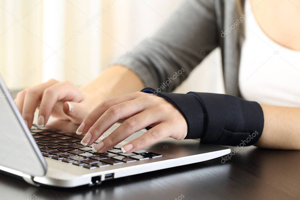 Woman hands with injured wrist working on line