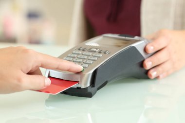 Customer typing pin in a credit card reader clipart