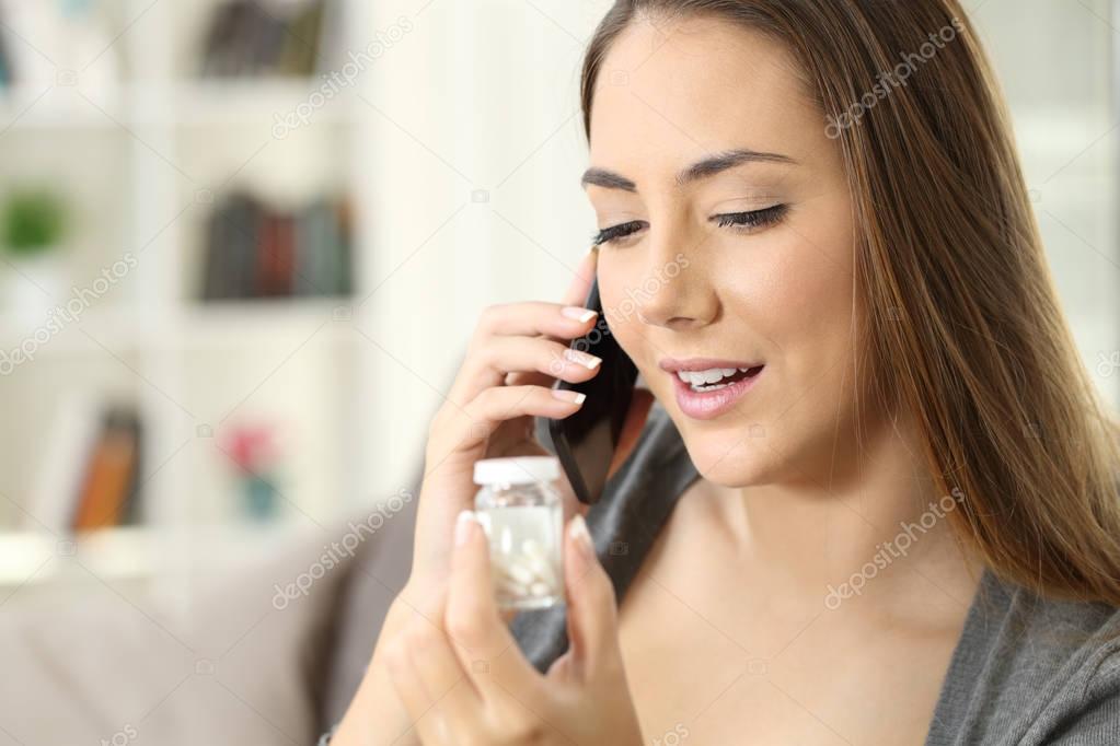 Happy woman calling doctor asking about bottle of pills