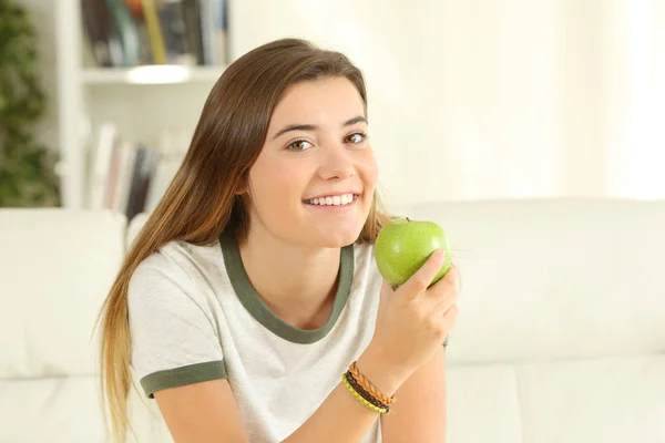 Adolescente mirándote sosteniendo una manzana — Foto de Stock