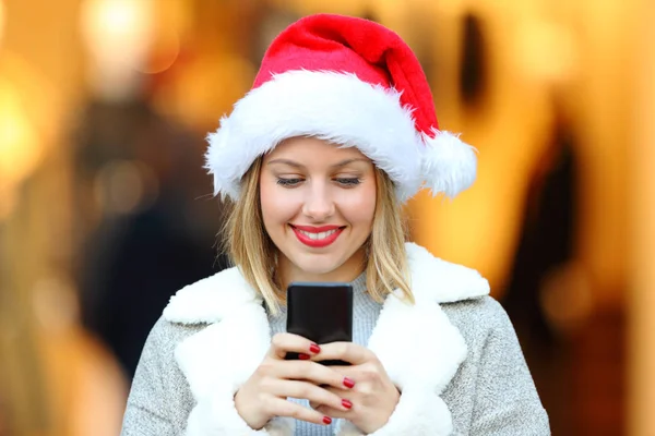 Девушка отправляет телефонные сообщения в рождественские праздники — стоковое фото