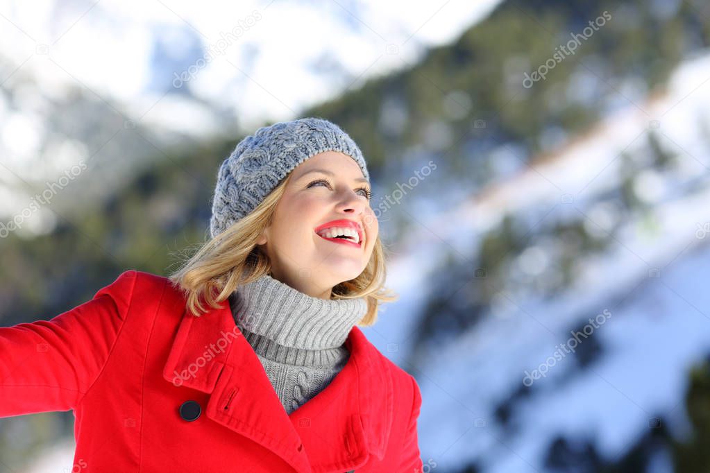 Candid woman dreaming on the mountain in winter