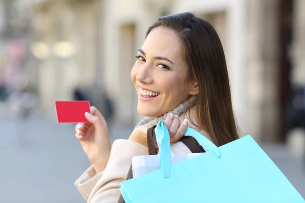 Comprador segurando sacos de compras e cartão de crédito — Fotografia de Stock