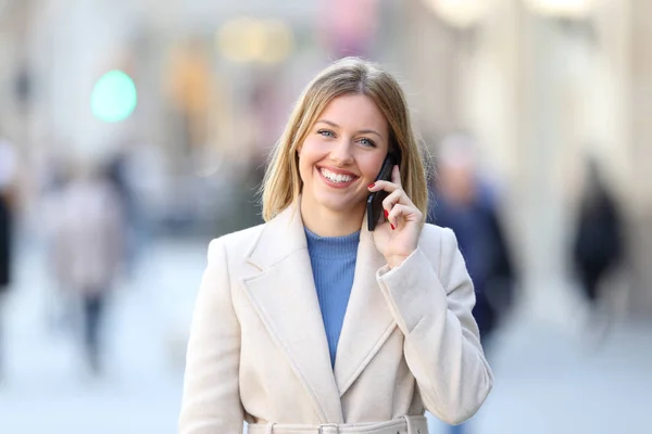 Senhora feliz chamando no telefone e olhando para a câmera — Fotografia de Stock