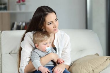 Sad woman looking away with her baby clipart