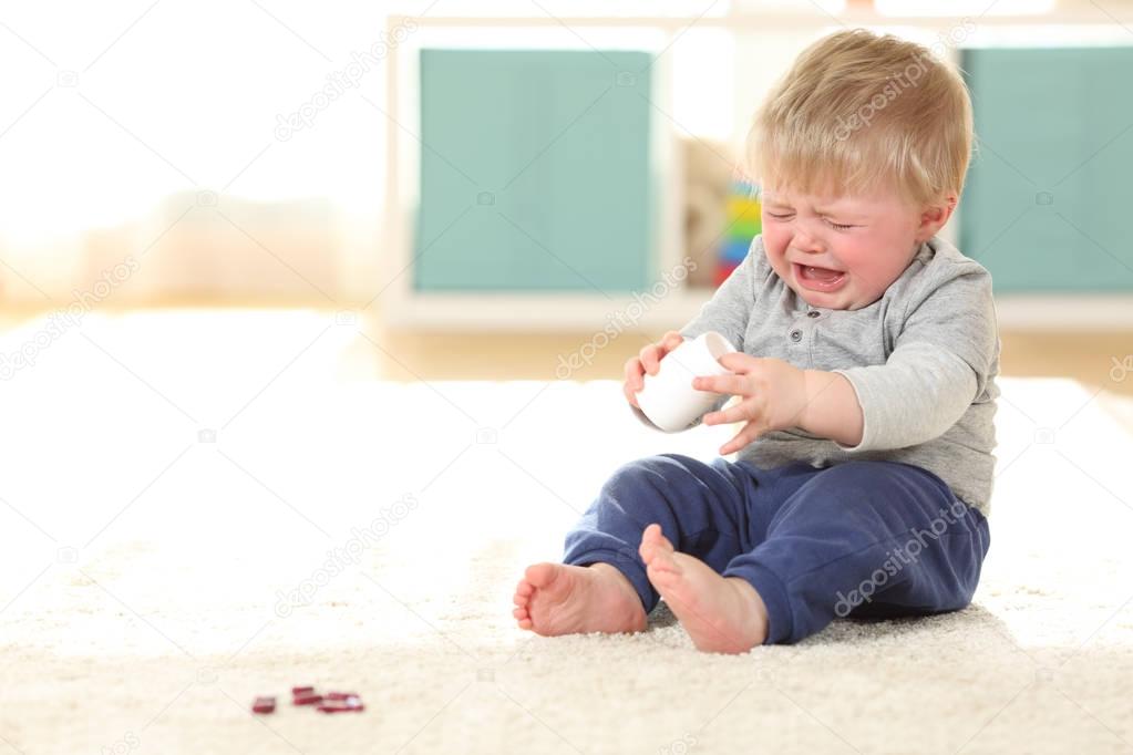 Baby crying in danger after eating some pills
