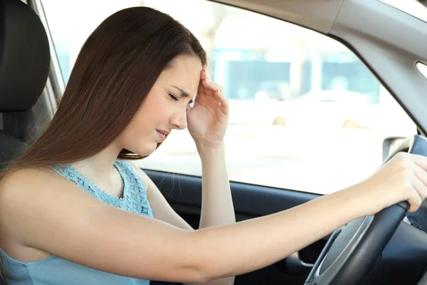 Driver suffering migraine driving a car — Stock Photo, Image