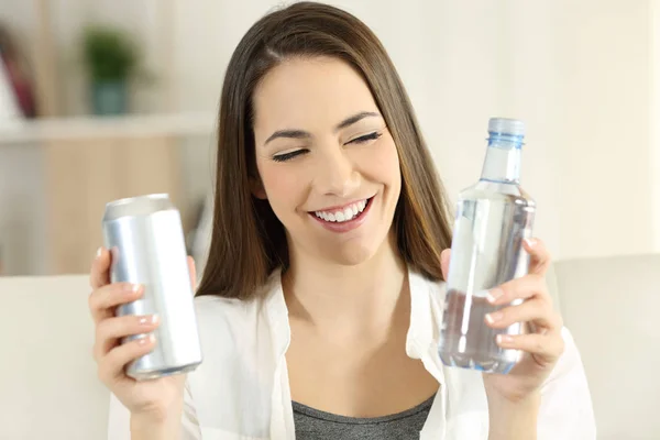 Mulher decidindo entre água ou refresco de refrigerante — Fotografia de Stock