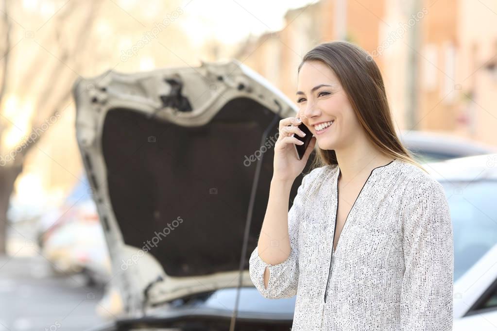 Smiley driver calling insurance after car breakdown