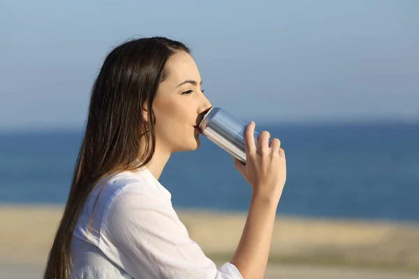 Kobieta, sody pitnej z puszki na świeżym powietrzu na plaży — Zdjęcie stockowe