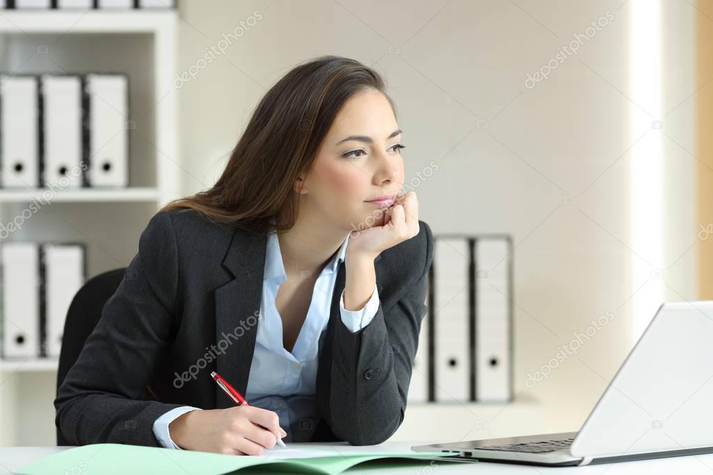 Businesswoman thinking looking away at office
