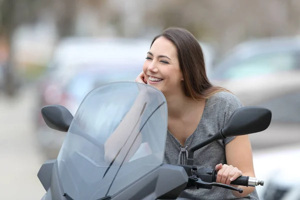 Happy motorbiker on a motorbike looking away — Stock Photo, Image