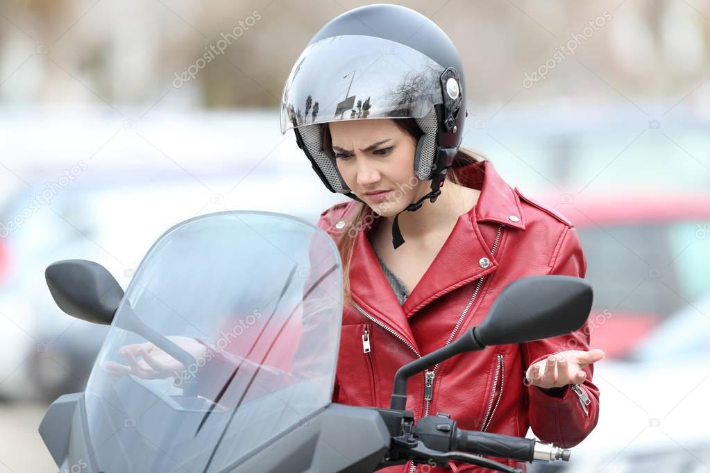 Angry biker on a broken down motorbike
