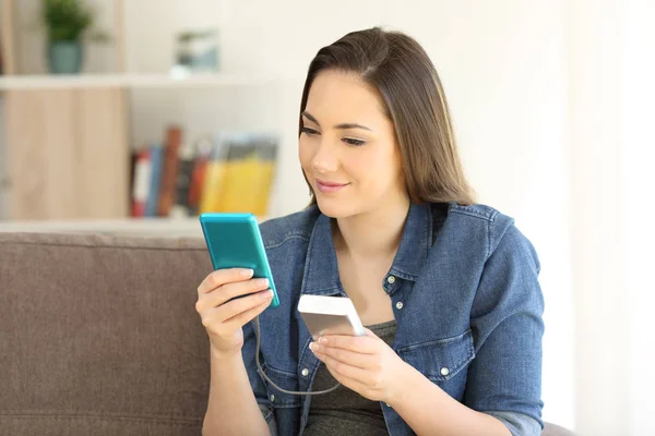 Gadis pengisian telepon pintar dengan pengisi portabel — Stok Foto