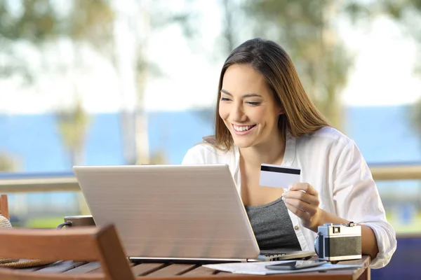 Turista paga en línea con una tarjeta de crédito en el hotel — Foto de Stock