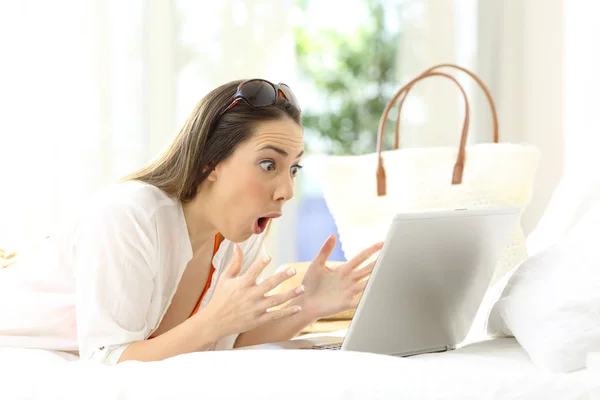 Excited woman reading online content on vacations Stock Image