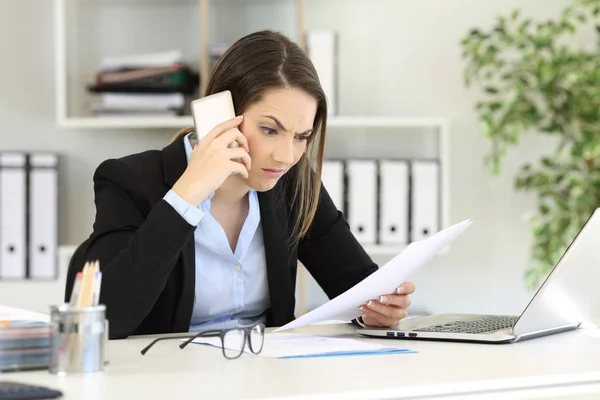 Angry executive calling on phone at office Royalty Free Stock Photos