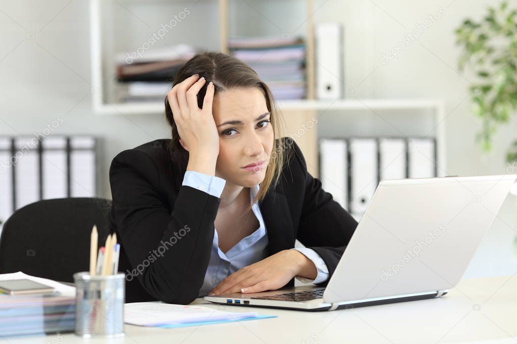 Worried office worker looking at camera