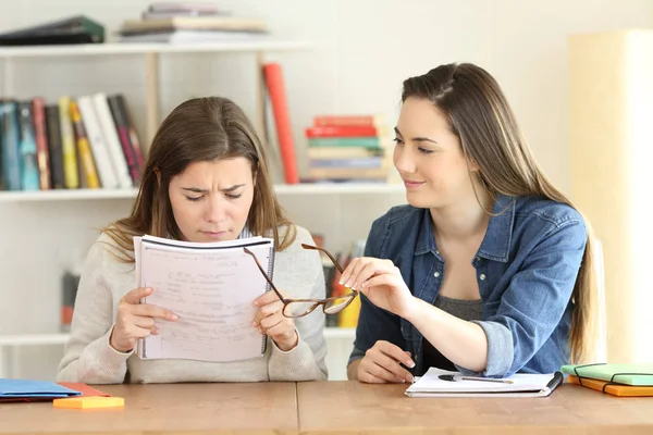 Student giving eyeglasses to her friend — Stock Photo, Image