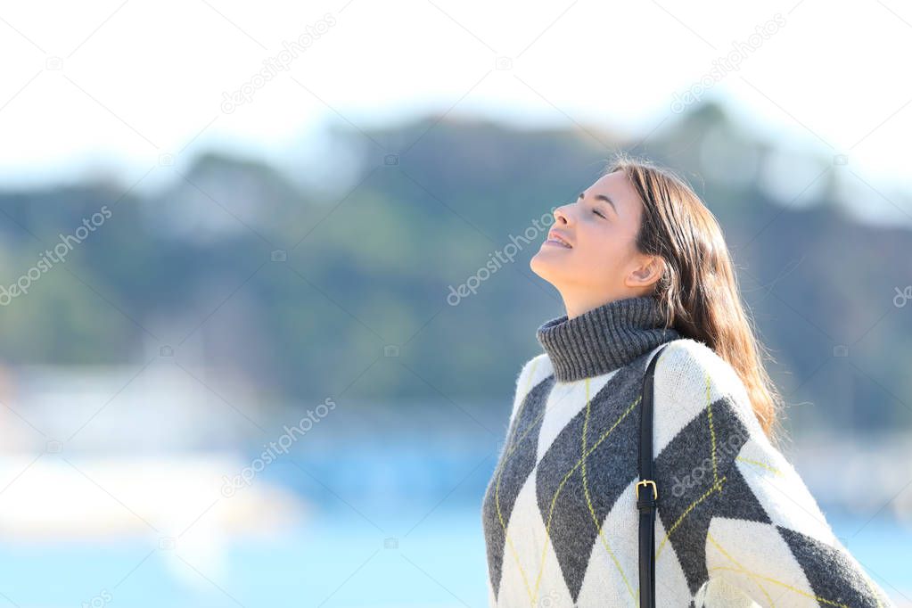 Woman with sweater breathing fresh air