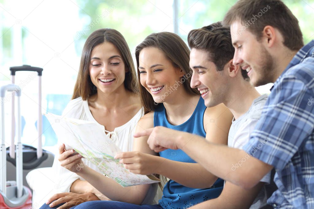 Group of tourists planning vacation checking maps