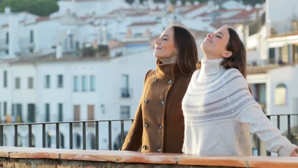 Two Relaxed Friends Breathing Fresh Air Winter Standing Balcony — 图库视频影像