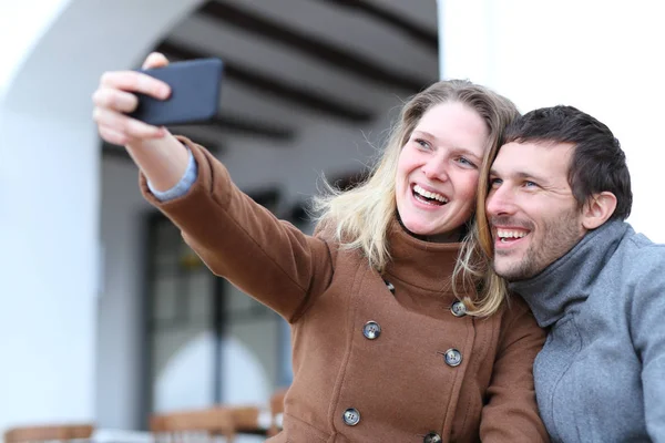 Pareja feliz de adultos tomando selfies en invierno —  Fotos de Stock