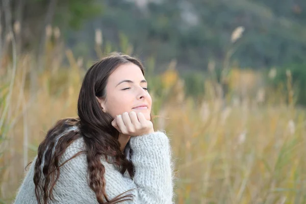 Розслаблена дівчина дихає свіжим повітрям у горі — стокове фото